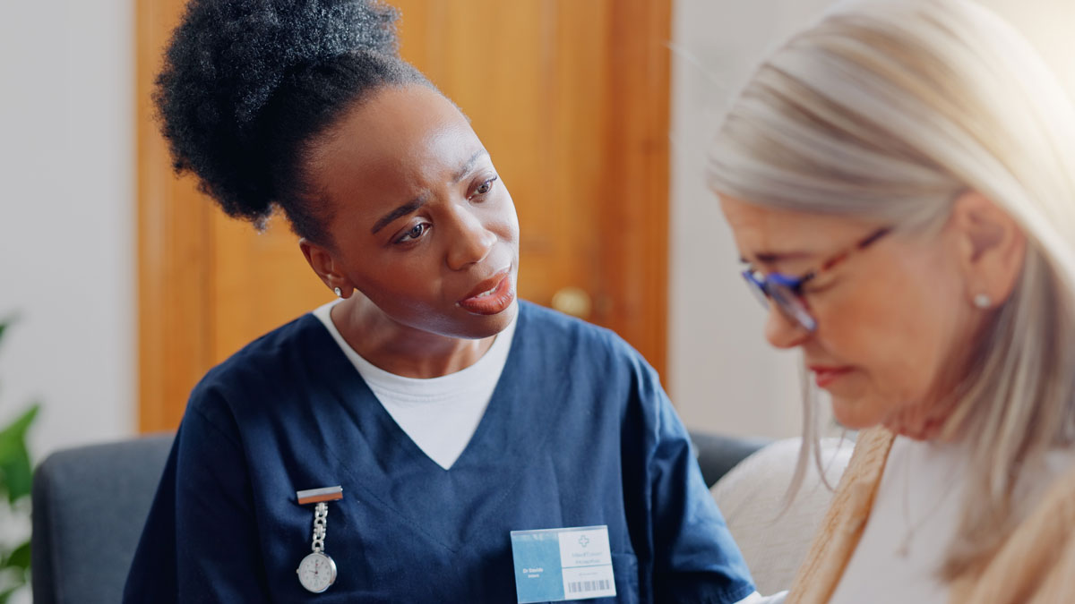 Frustrated, sad woman speaking or nurse with results in consultation for bad news or cancer. Stress, lady talking or caregiver with a depressed mature patient for empathy, sympathy or help in home