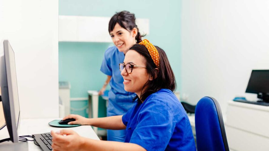 Two nurses using a computer in a x-ray room