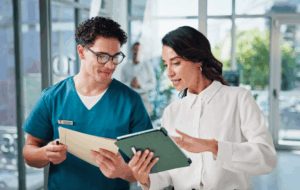 Doctors, conversation and people in hospital, tablet and teamwork with email for treatment approval. Employees, coworking and medical with healthcare, discussion and tech with results and schedule