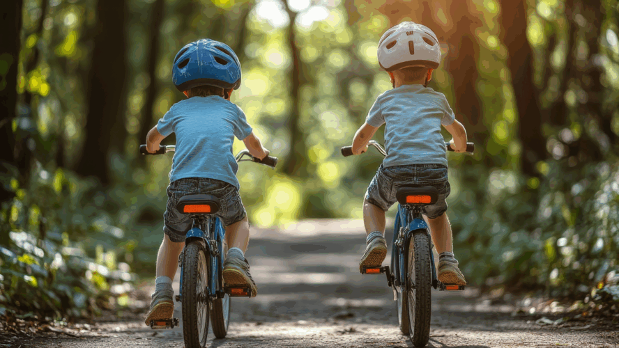 Family in the park on bicycles. two sibling brothers kids boys compete in riding. view from back