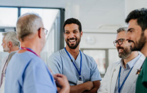 Team of doctors discussing something at hospital corridor.