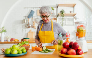 healthy asian aunt retired female woman enjoy making cook clean food breakfast for her healthy food lifestyle,smiling cheerful woman silver hair with tattoo prepare smoothie juice drink for her health
