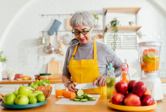 healthy asian aunt retired female woman enjoy making cook clean food breakfast for her healthy food lifestyle,smiling cheerful woman silver hair with tattoo prepare smoothie juice drink for her health