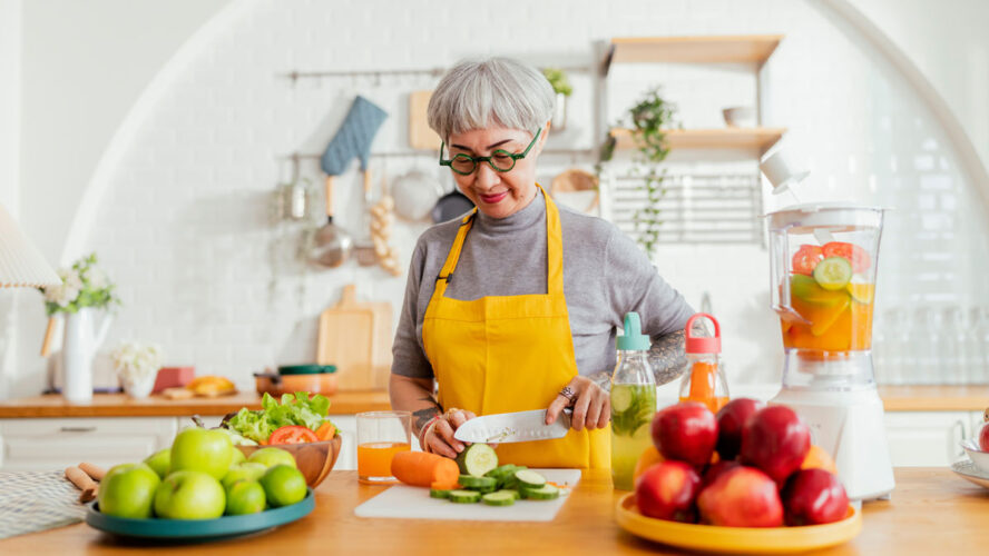 healthy asian aunt retired female woman enjoy making cook clean food breakfast for her healthy food lifestyle,smiling cheerful woman silver hair with tattoo prepare smoothie juice drink for her health