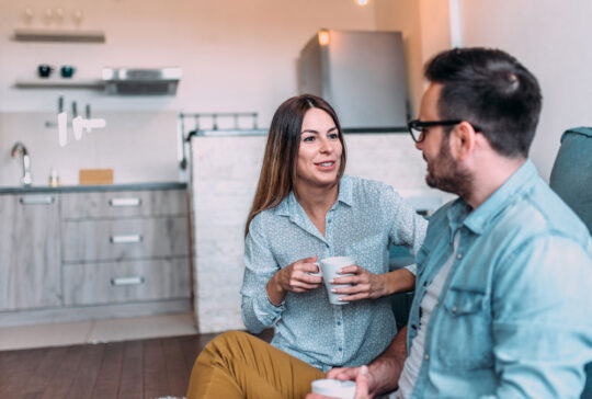 Cute couple talking indoors.