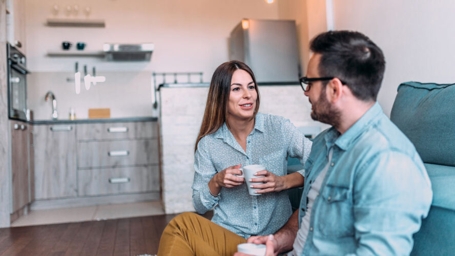 Cute couple talking indoors.