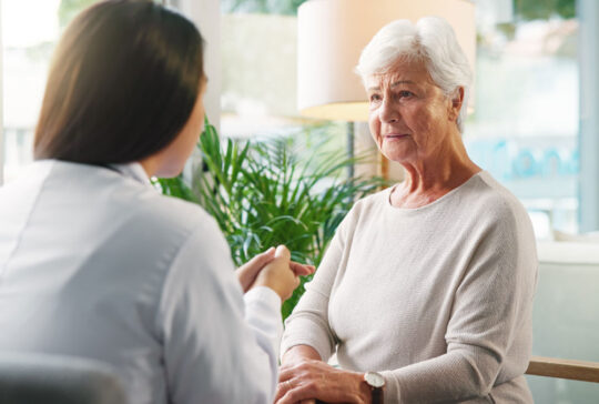 Doctor, senior woman and sad with talk for diagnosis, info or bad news for health services in retirement. Elderly person, stress and medical consultation with worry, listen or results at nursing home