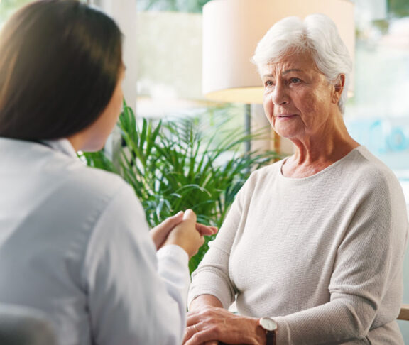 Doctor, senior woman and sad with talk for diagnosis, info or bad news for health services in retirement. Elderly person, stress and medical consultation with worry, listen or results at nursing home