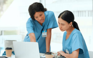 Doctors, women and laptop for research, brainstorming or internet with results, medical website or email. People, colleagues or nurses with pc, online reading or schedule for hospital ward or network