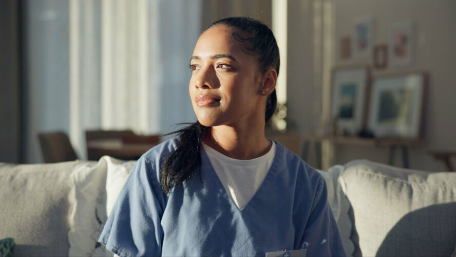 Calm, thinking and a nurse or woman on the sofa to relax from a career in healthcare in a house. Smile, peace and a medical employee or doctor with an idea or vision on the couch for a memory