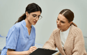 A professional gynecologist discusses health concerns with a patient in a contemporary clinic.