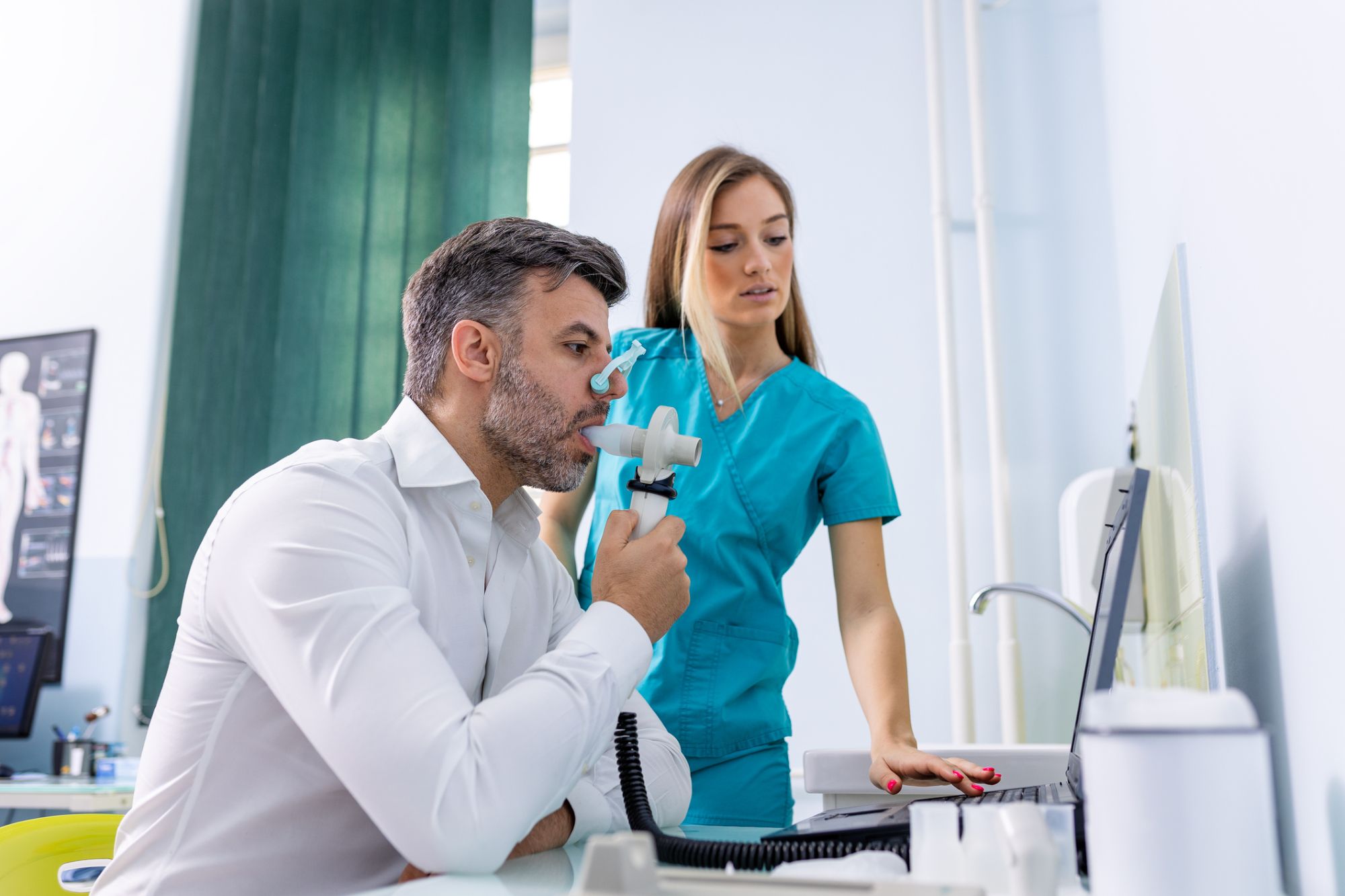 Adult man testing breathing function by spirometry having health problem. Diagnosis of respiratory function in pulmonary disease.