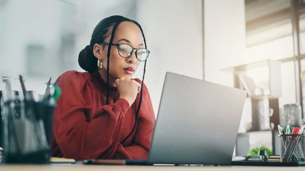 Thinking, laptop and business woman focus, planning and reading online news report, project feedback or research ideas. Wonder, problem solving and professional female designer with doubt over design
