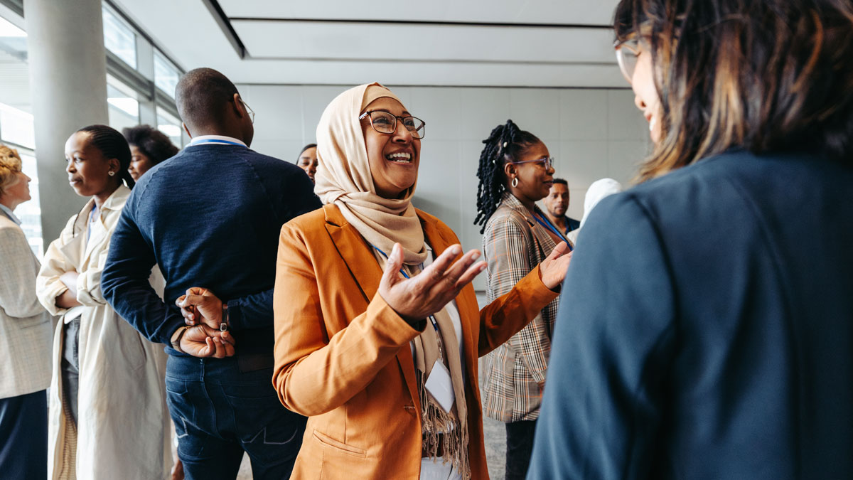 Smiling Muslim businesswoman sharing and talking during a networking event