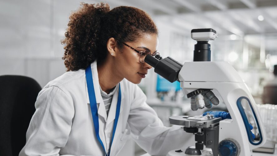 Microscope, woman check and virus research of science study with healthcare, scientist and laboratory work. Analysis, testing and medical professional with investigation for scientific journal - stock photo