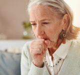 Senior, sick woman and cough with viral infection for chronic illness, influenza or virus at home. Elderly, female person or cold with hayfever, bronchitis or flu symptoms for lung disease or sinus