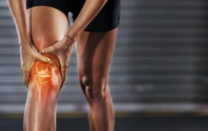 Knee injury, red muscle and man exercise with medical pain, body strain and sports emergency. Legs, wound and fitness accident from workout, arthritis and skeleton anatomy for orthopedic first aid