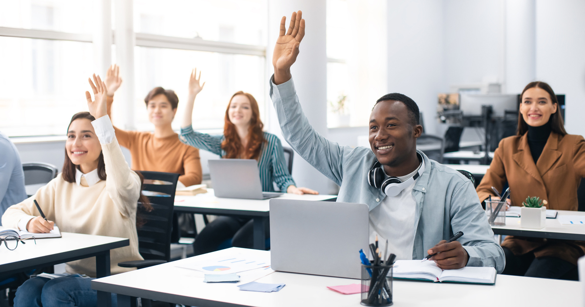 Presentation, Convention Concept. Portrait of smiling international people participating in seminar at modern office, raising hands up to ask question or to volunteer, diverse group sitting at tables