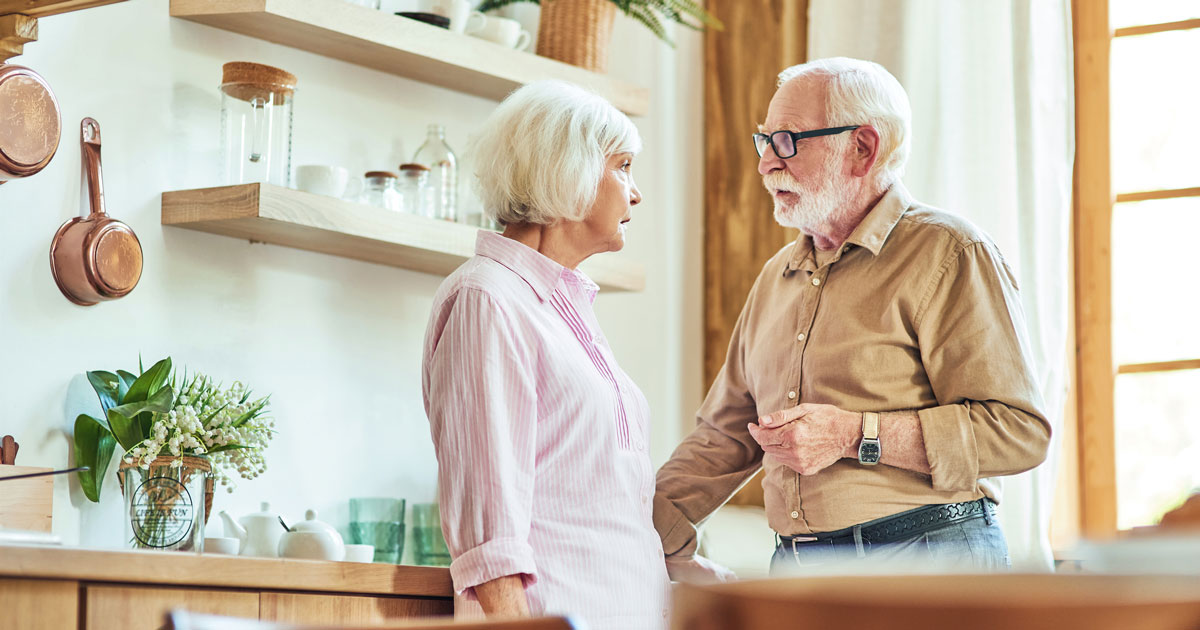 Senior couple discussing something in the kitchen