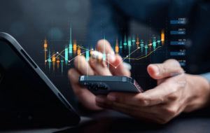 Businessmen investor think before buying stock market investment using smartphone to analyze trading data.