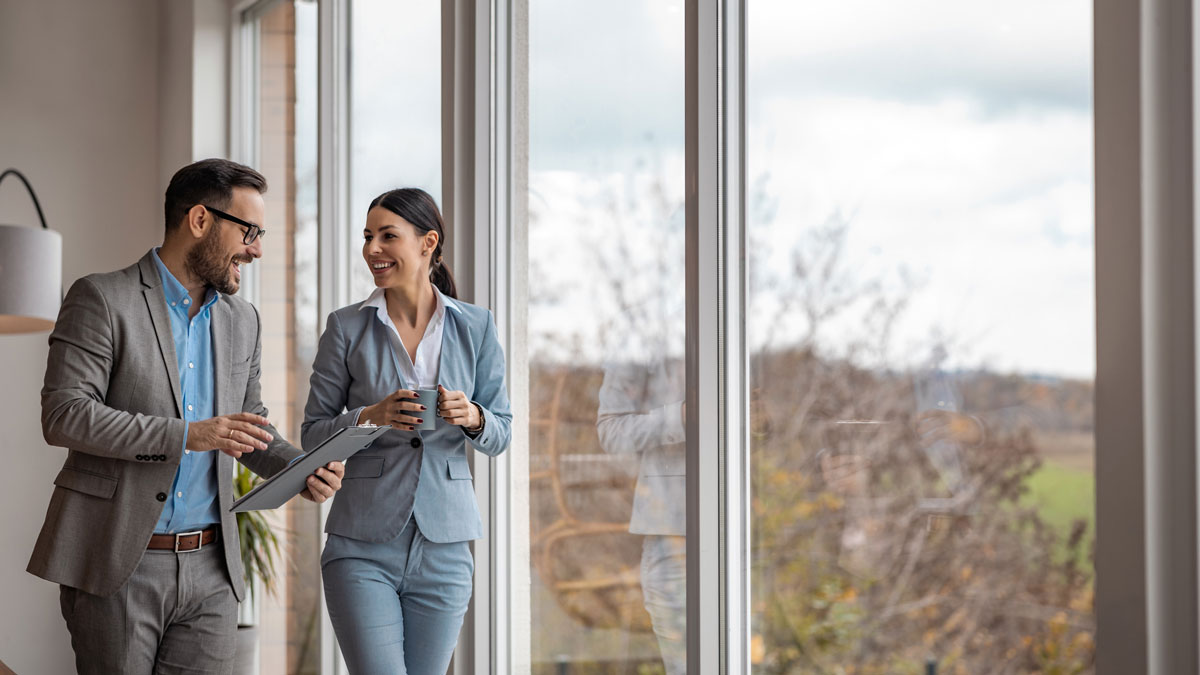 Real estate agent with woman closing a deal and signing a contract