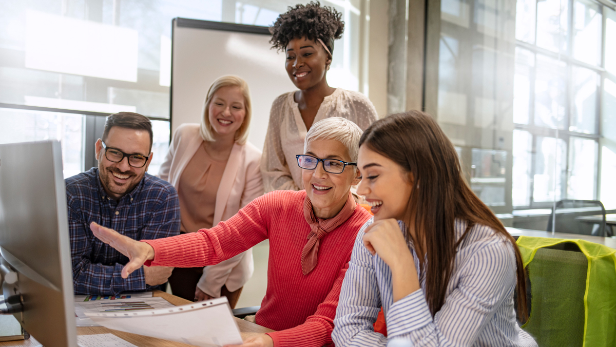 Senior designer giving some new ideas about project to her partners in conference room. Business people discussing over new business project in office. Group of businesspeople or designers work with new startup project in office.