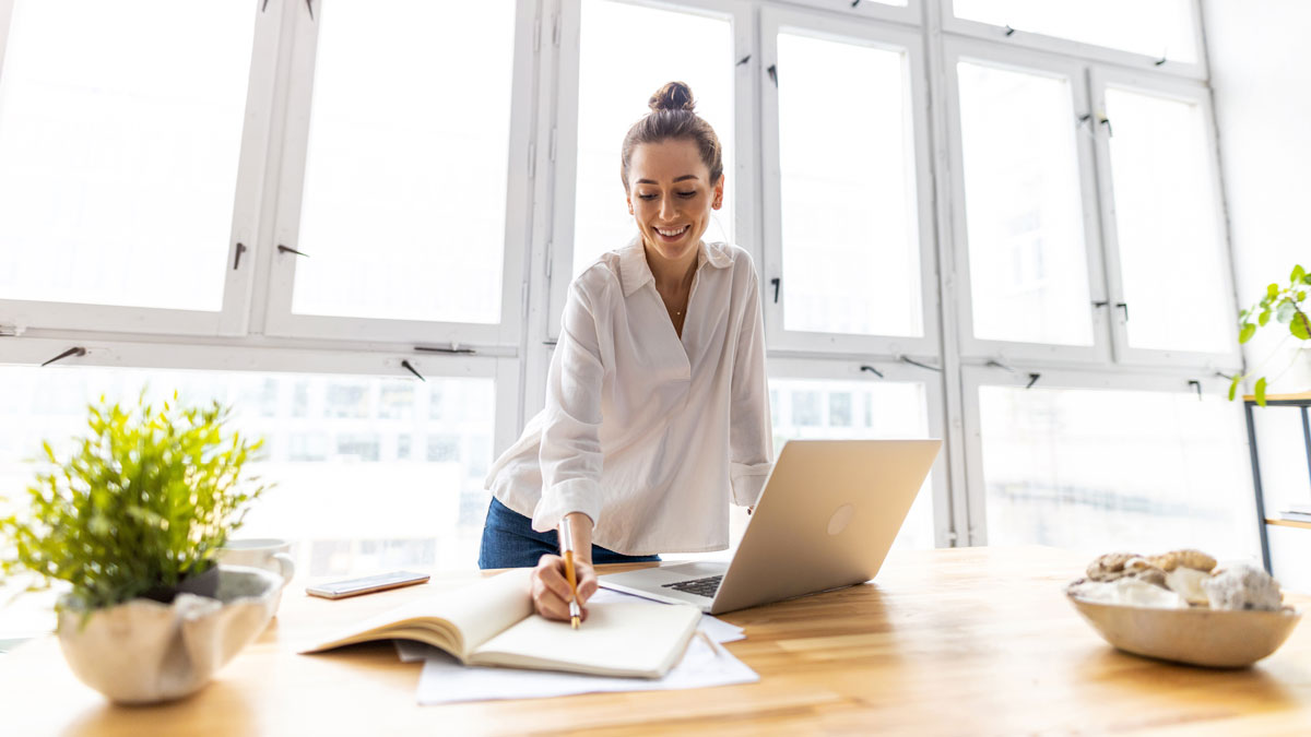 Young female freelancer working in loft office