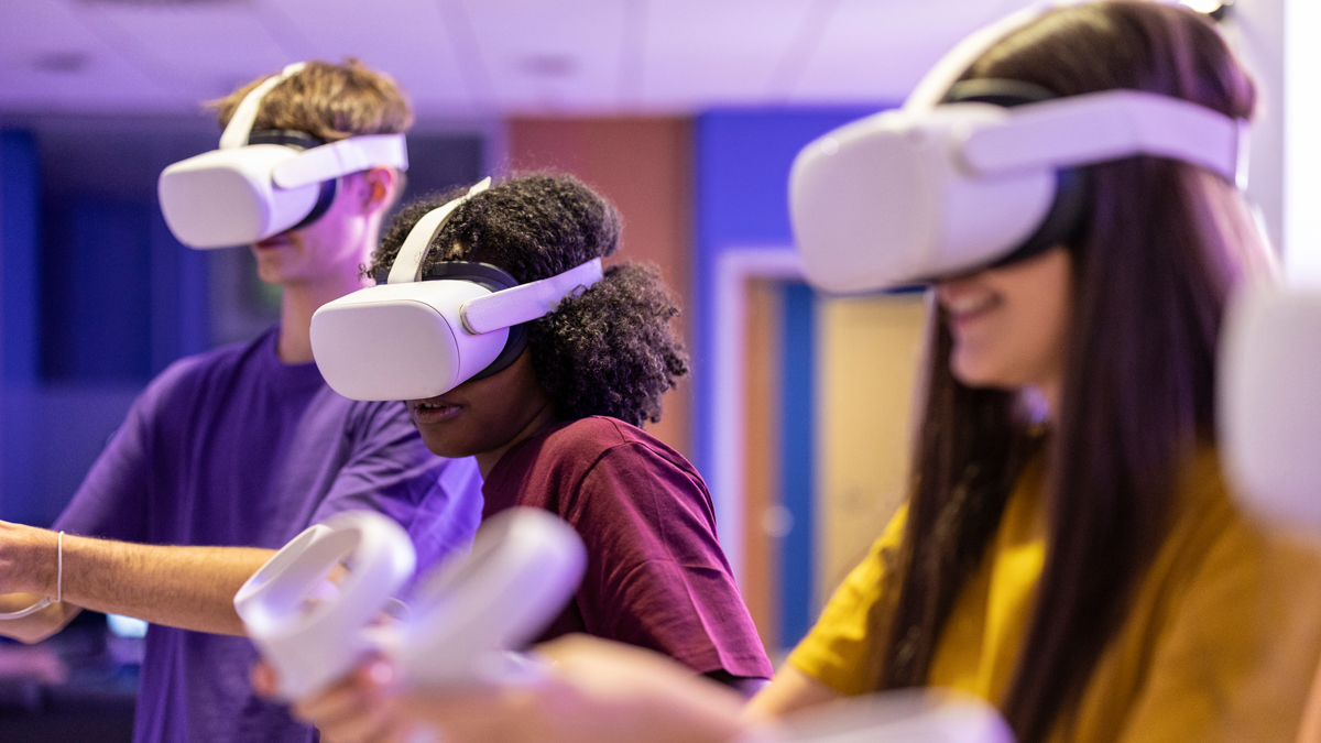 Group of multicultural friends gamers with virtual reality glasses playing video games