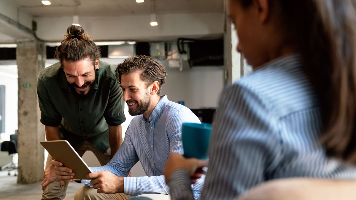 Portrait of success business colleagues working, smiling together in office.