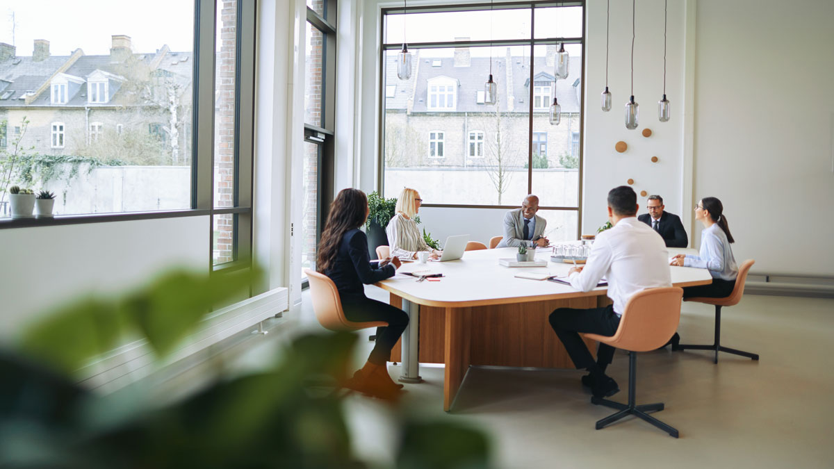 Smiling group of diverse businesspeople having a boardroom meeti