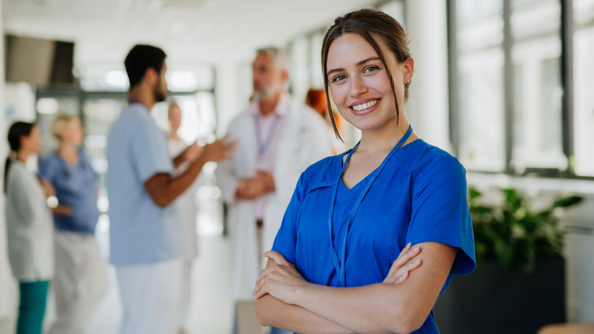 Portrait of young woman nurse at hospital corridor.