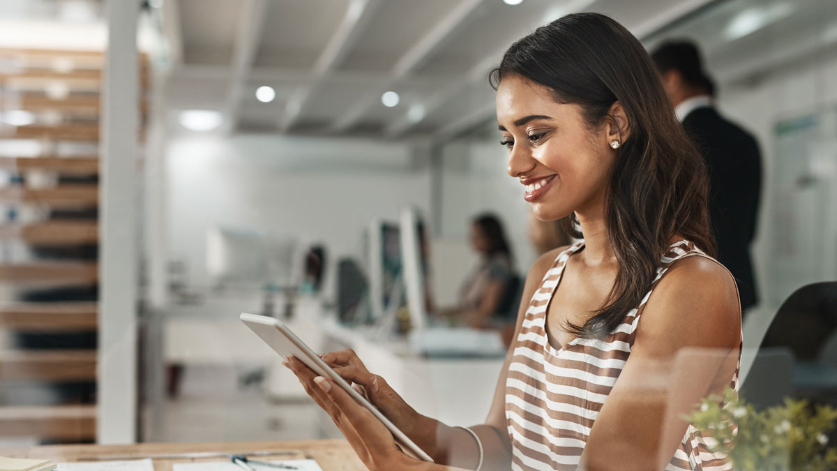 Woman, tablet and reading at night in office with inspiration, smile and editing story at global news company. Journalist, writer and person with touchscreen, article or newsletter at media agency