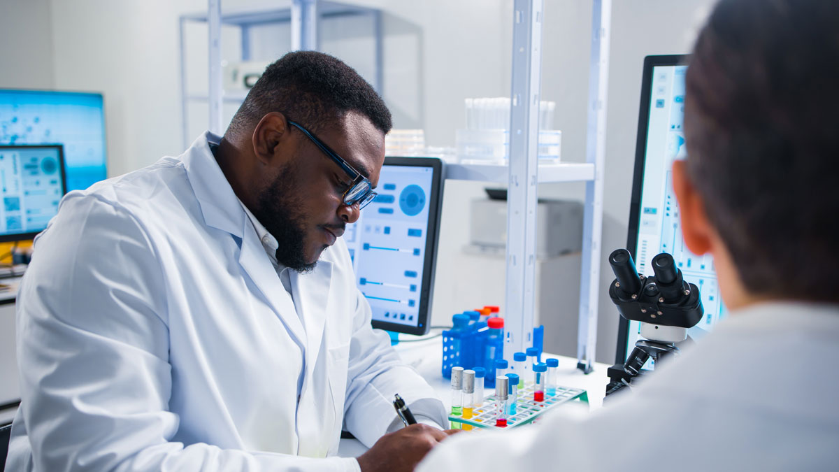 Professional team of scientists is working on a vaccine in a modern scientific research laboratory. Genetic engineer workplace. Future technology and science.