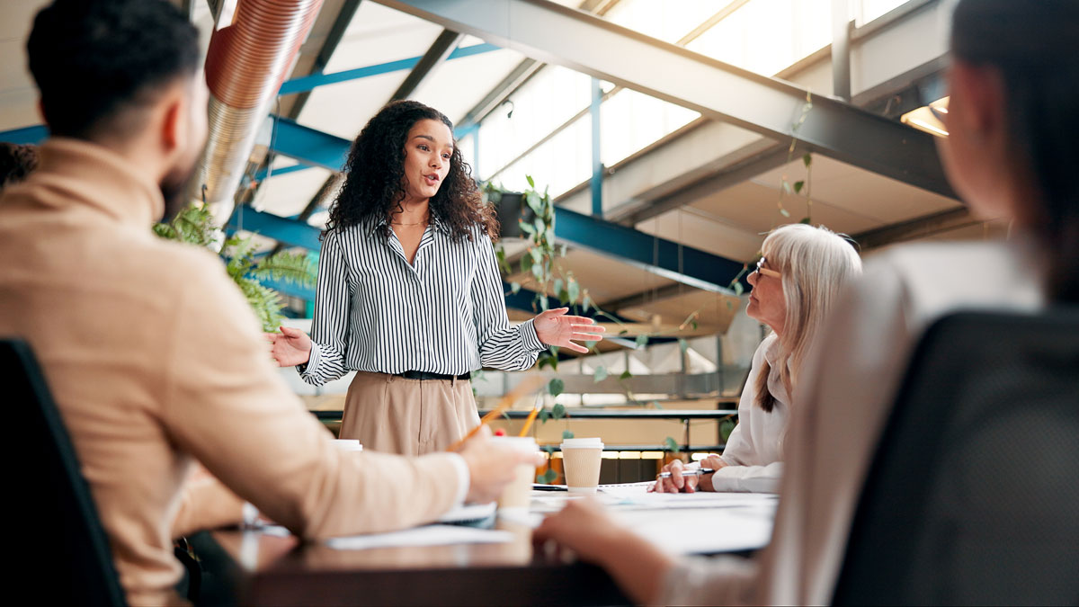 Brainstorming, speaker and woman in boardroom, creative and brand specialist with ideas for project. Business, team and people with strategy for target audience, trends and speech for workshop