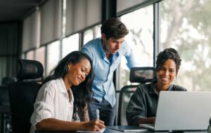 Group of busy happy diverse professional business team people working in office using digital tablet