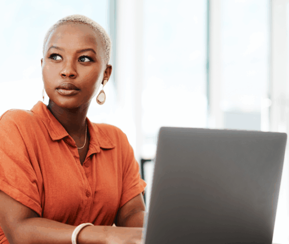Thinking, online and black woman with laptop, serious and typing of ideas in office and copywriting. Writer, working and creative for website on desk, reading and confident in company and person