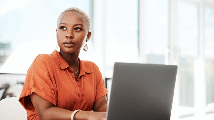 Thinking, online and black woman with laptop, serious and typing of ideas in office and copywriting. Writer, working and creative for website on desk, reading and confident in company and person