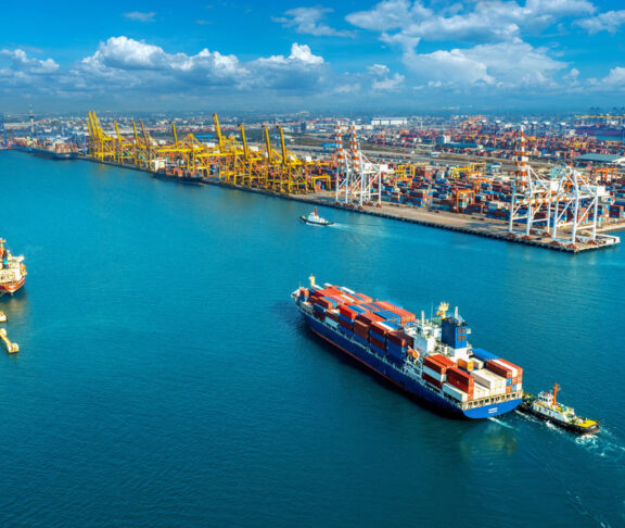 Aerial view of cargo ship and cargo container in harbor