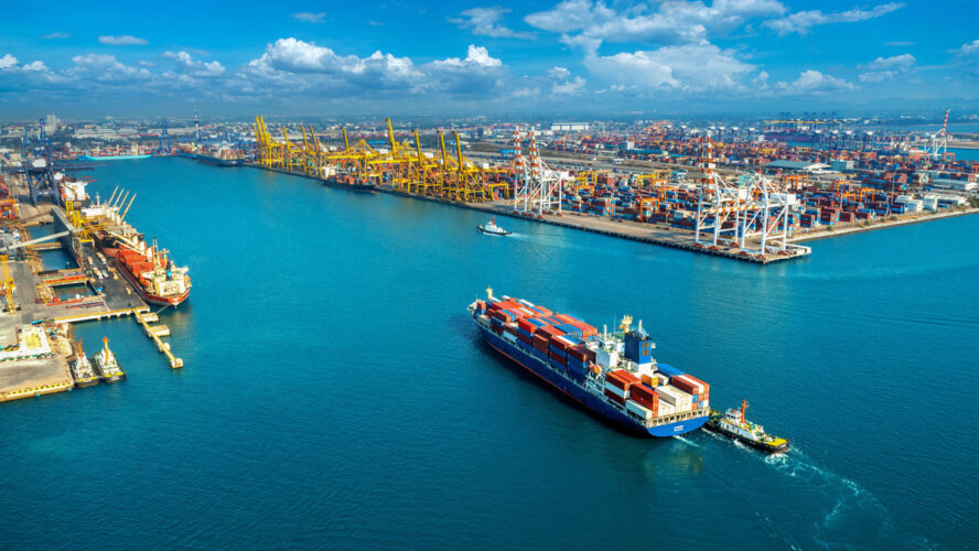 Aerial view of cargo ship and cargo container in harbor