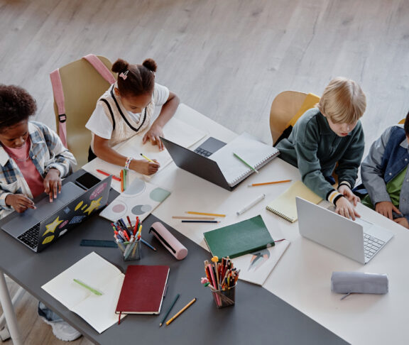 Top View of Children Studying Together at Table