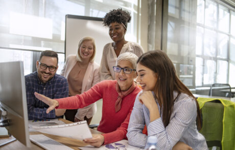 Senior designer giving some new ideas about project to her partners in conference room. Business people discussing over new business project in office. Group of businesspeople or designers work with new startup project in office