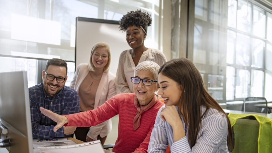 Senior designer giving some new ideas about project to her partners in conference room. Business people discussing over new business project in office. Group of businesspeople or designers work with new startup project in office