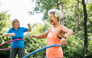 Senior woman exercising with a hula hoop
