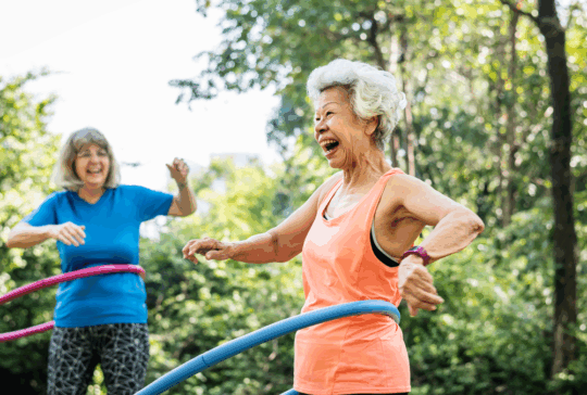 Senior woman exercising with a hula hoop
