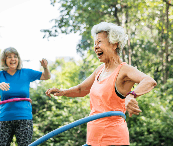 Senior woman exercising with a hula hoop
