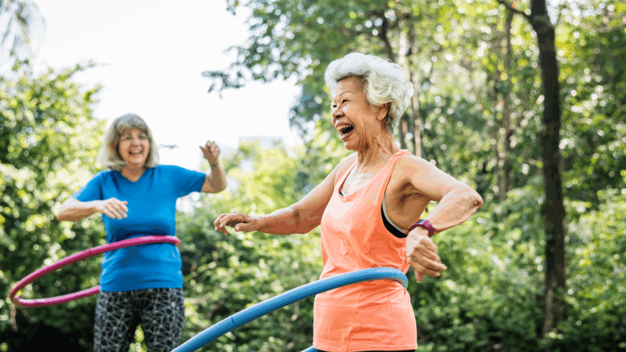 Senior woman exercising with a hula hoop