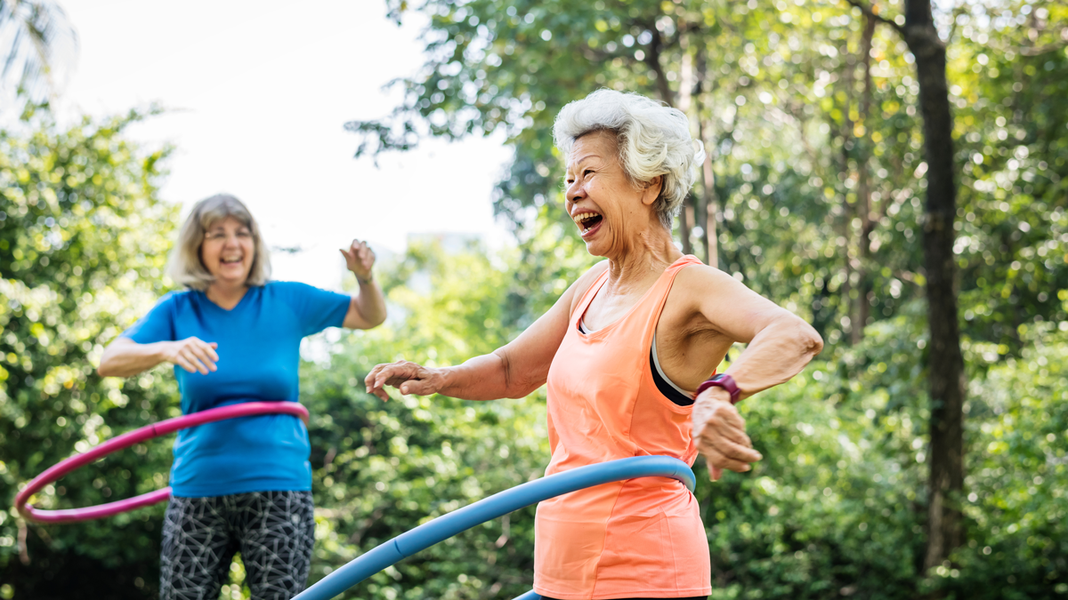 Senior woman exercising with a hula hoop