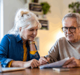 Senior couple sitting at the table discussing home finances