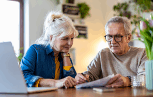 Senior couple sitting at the table discussing home finances