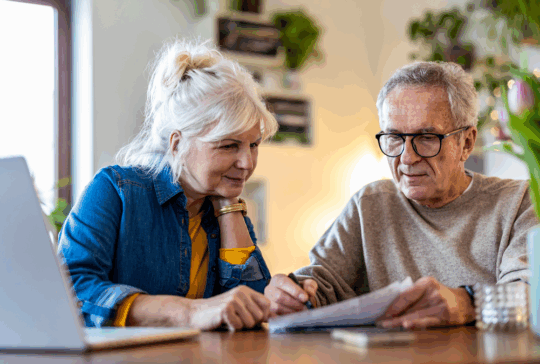 Senior couple sitting at the table discussing home finances